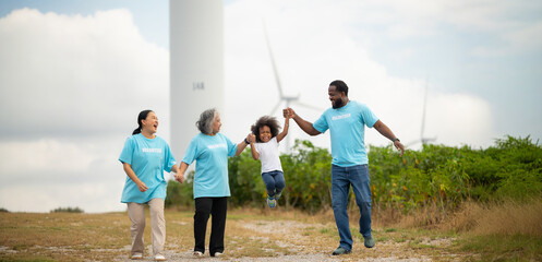 Volunteers are walking behind a windmill farm, volunteer charity people. charity community service event, ngo business and outreach, Group Diverse people meeting at park for donation