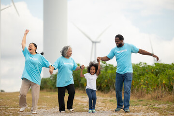 Volunteers are walking behind a windmill farm, volunteer charity people. charity community service event, ngo business and outreach, Group Diverse people meeting at park for donation