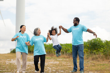 Volunteers are walking behind a windmill farm, volunteer charity people. charity community service event, ngo business and outreach, Group Diverse people meeting at park for donation