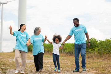 Volunteers are walking behind a windmill farm, volunteer charity people. charity community service event, ngo business and outreach, Group Diverse people meeting at park for donation