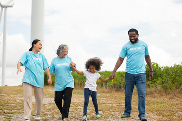 Volunteers are walking behind a windmill farm, volunteer charity people. charity community service event, ngo business and outreach, Group Diverse people meeting at park for donation