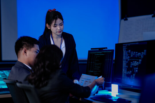 Data integrity check night shift Diverse team meticulously audits financial performance comparing figures tablet screen printed reports ensuring accuracy crucial validation process underway hub. - Powered by Adobe