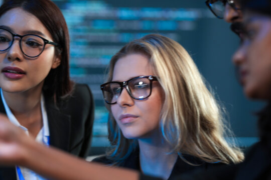Code review success moment. Smiling female developers react positively colleague points out elegant solution code screen late night agile sprint win team synergy achieves goals faster.
