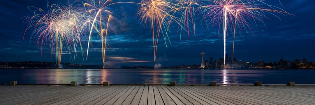 Colorful fireworks exploding over water at night with city skyline
- Powered by Adobe