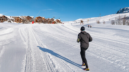 Running on the ski slopes in winter at Alpe d'Huez