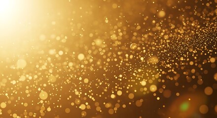 Golden particles and bokeh lights shimmering against a dark background with bright light source image