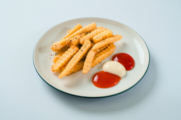 Golden Crinkle Cut French Fries with Ketchup and Mayonnaise on a White Plate