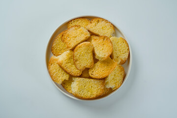 flat lay of Stacked dry bread snacks served on a plate isolated on a white background.