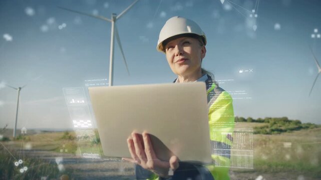 Female engineer holding laptop and reviewing renewable energy data near wind turbines. Caucasian professional standing in open field analyzing hologram charts rising around her in wide landscape. - Powered by Adobe