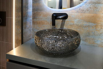 A beautiful glass sink in a dark bathroom.