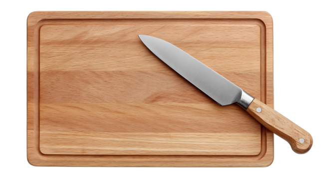 A wooden cutting board with a groove around the edge and a knife lying diagonally across the board