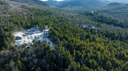 Aerial winter view of evergreen forest and mountains near Keene, New York in the Adirondacks.