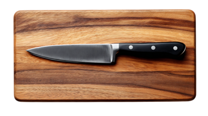 A sharp kitchen knife with black handle resting on a wooden cutting board in a studio setting view