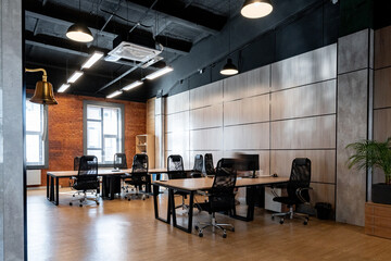 Modern office space with several workstations and natural light on a weekday