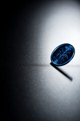 強い光に浮かぶ一円玉一枚のミニマルな硬貨イメージ