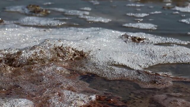 The foam on the surface of the Kuyalnik estuary