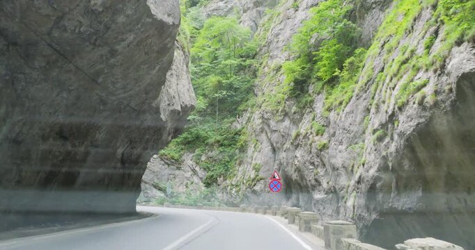 Front view from car passing through the wild Bicaz Gorges in Romania