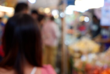 Fototapeta premium Blurred of Glowing Market Trails with Shifting Silhouettes
