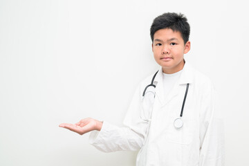 Young Asian Boy Dressed as Doctor with Stethoscope Showing Palm Hand Presenting Copy Space