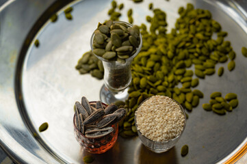 Still life with sunflower, sesame, and pumpkin seeds in glass cups