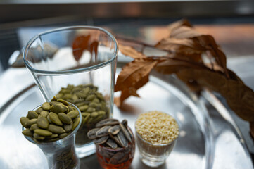 Still life with sunflower, sesame, and pumpkin seeds in glass cups
