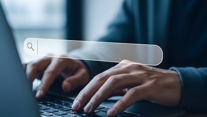 Hands typing on laptop with search bar overlay for online research