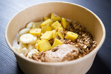 A healthy breakfast bowl with yogurt, granola, and fresh fruits.