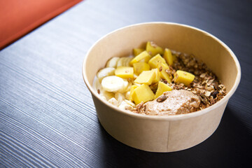 A healthy breakfast bowl with yogurt, granola, and fresh fruits.