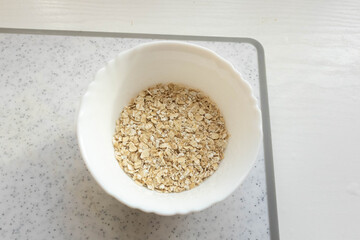 Bowl of oats prepared for a healthy breakfast in a cozy kitchen setting a bright morning