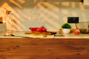 Fresh produce on wooden countertop with warm sunlight streaming in during a cozy kitchen afternoon copy space