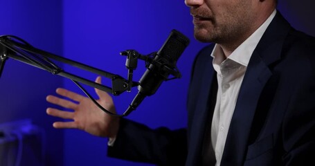 business podcast or radio interview recording. businessman talking in microphone in broadcasting studio