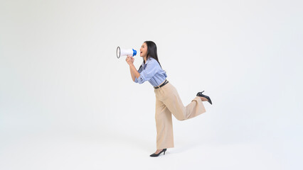 Young Woman Enthusiastically Engages With a Megaphone in a Bright Studio Setting