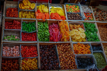 Colorful assortment of dried fruit cubes and slices at market