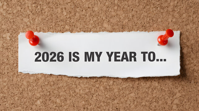 2026 is my year to motivational message on torn paper pinned to a corkboard concept for goal setting and new year resolutions