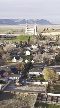 Flying over a small town in Utah with an LDS Temple in the distance