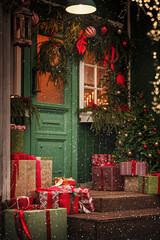 Outdoor decoration with christmas tree and festive gifts on a snowy winter night.
