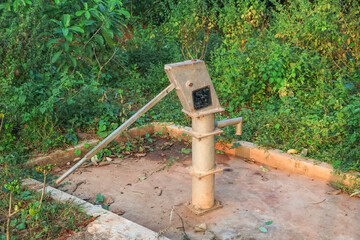 Old hand operated water pump in rural India. Metal hand pump.