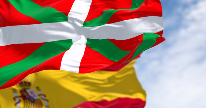 Basque Country and Spanish flags waving in the wind