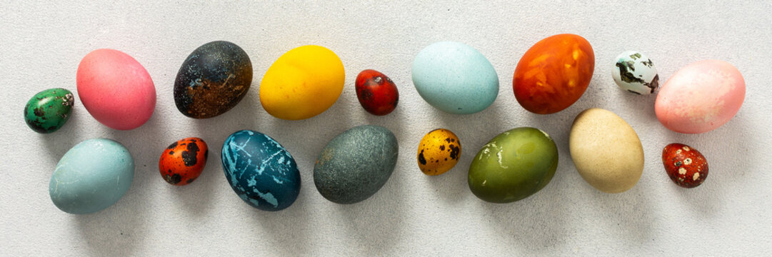 Various Easter eggs in vibrant colors and patterns are neatly arranged, showcasing the joy and creativity associated with spring celebrations and family gatherings, banner