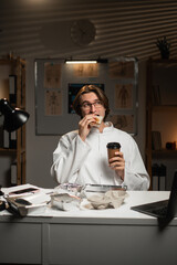 Male doctor receiving essential takeaway food and coffee delivery while working long night shift