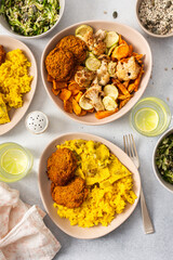 A colorful spread featuring rice with rhubarb fried eggs, baked sweet potato, and sauteed cauliflower and zucchini