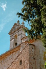 Fototapeta premium Historic Stone Bell Tower Against a Bright Blue Sky