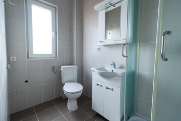 Small white apartment bathroom. Small bathroom with a toilet, sink and a mirror