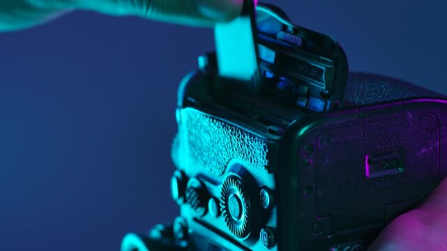 Close Up of Hand Removing Memory Card into Camera