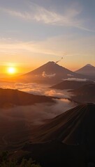 Sunset over mountains  clouds volcano smoking