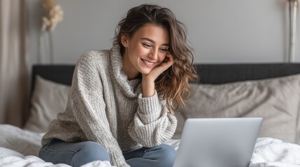 A young woman, dressed in a soft sweater, sits on her bed with her laptop open, appearing absorbed in her thoughts. The woman is surrounded by a cozy bedroom atmosphere, creating a