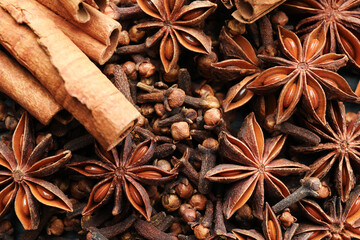 Mulled wine spices. Anise stars, cloves and cinnamon sticks as background, top view