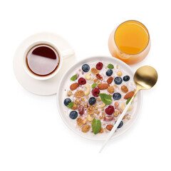 Healthy breakfast. Oatmeal with nuts, berries, milk in bowl, tea and juice isolated on white, top view