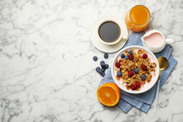 Tasty breakfast. Granola with yogurt and fruits served on white marble table, flat lay. Space for...