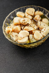 Garlic slices in flavored oil roasted garlic slice in oil fast food natural tasty appetizer fresh delicious gourmet food background on the table rustic top view copy space vegetarian or vegan food
